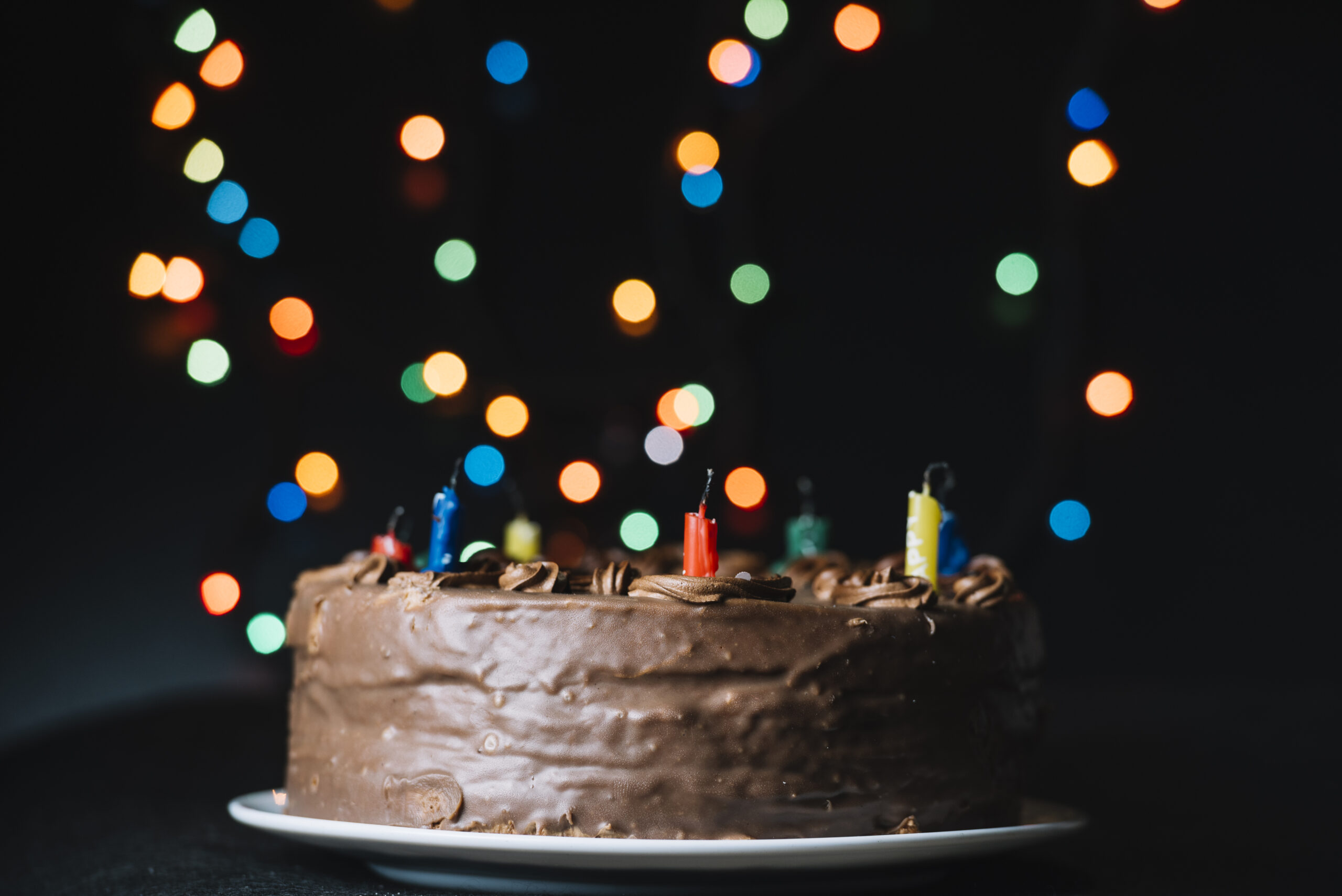 chocolate-cake-against-glitter-bokeh-lights-black-backdrop